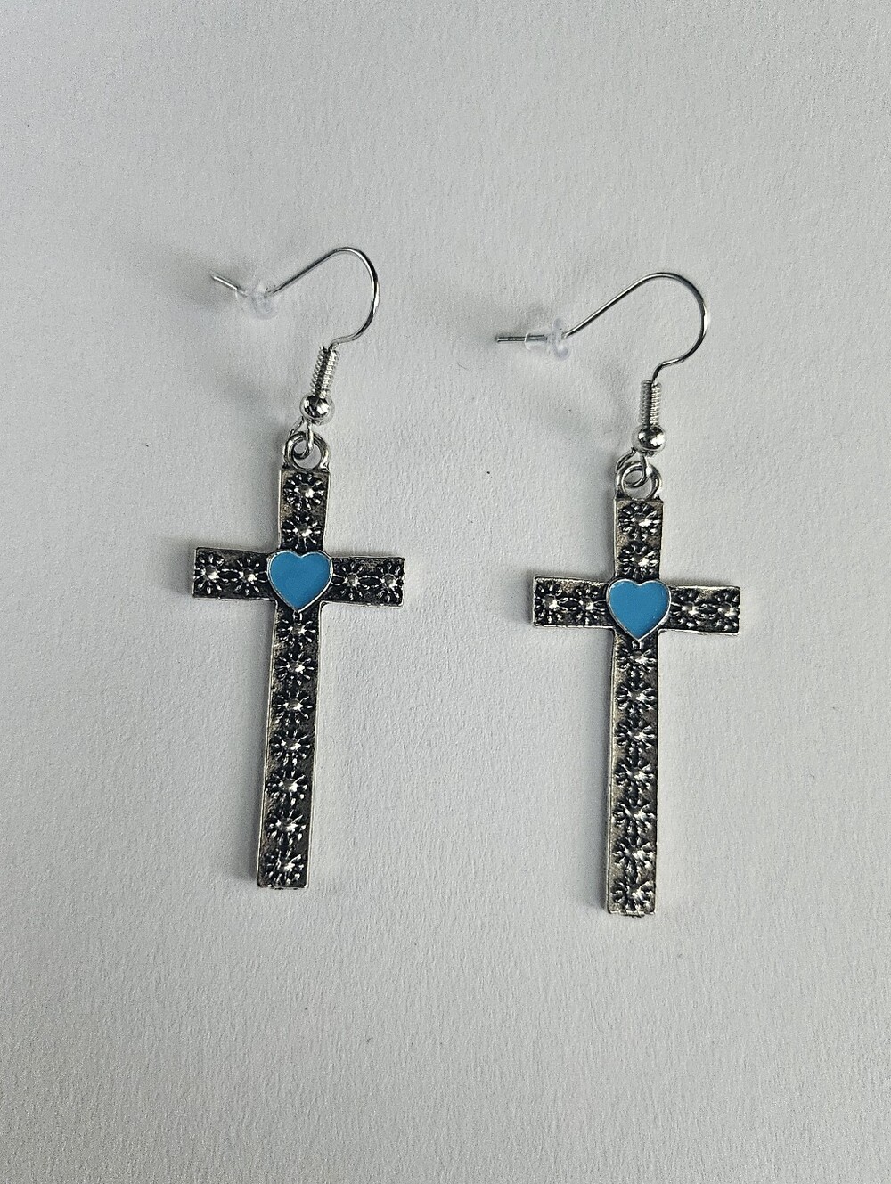 Cross earrings with blue heart and flower designs, new without tags.